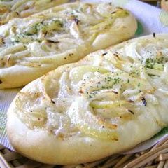 A picture of Tarte Flambé (Baked Onion Flatbread).
