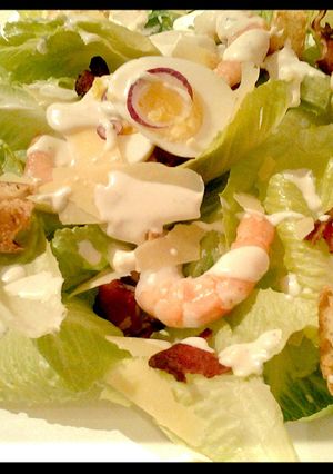 A picture of Ceaser salad with prawns.