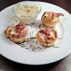 A picture of Baked Eggs in Corn Muffins with Sausage Cream Gravy Dipping Sauce.