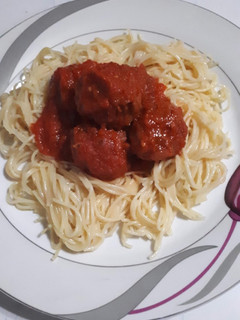 A picture of Meatballs in sauce.