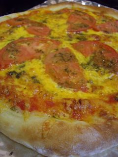 A picture of American Pizza with Basil Pesto.