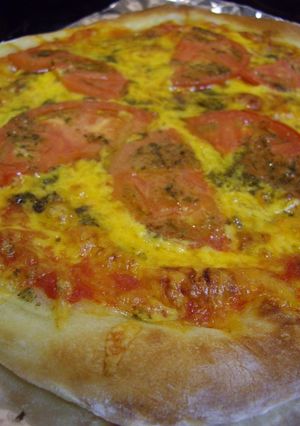 A picture of American Pizza with Basil Pesto.