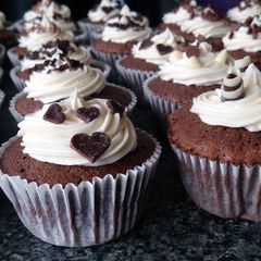 A picture of chocolate cupcakes with buttercream and chocolate toppings..