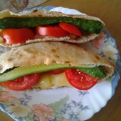 A picture of Chicken sandwich with fresh veggies.
