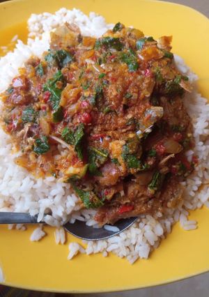 A picture of Garden egg sauce with basilica leaves.