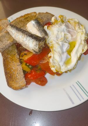Una foto de Pisto de Pimientos y Calabacín con Sardinillas y Huevo Frito