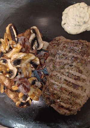 A picture of Grilled Ribeye Steak with Grilled Shallots and Chestnut Mushrooms.