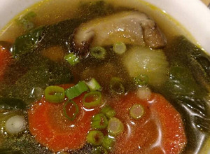 A picture of Shiitake mushroom and bok choy soup.