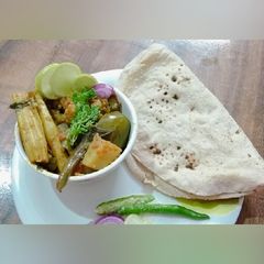 A picture of Mix veggies with drumsticks.