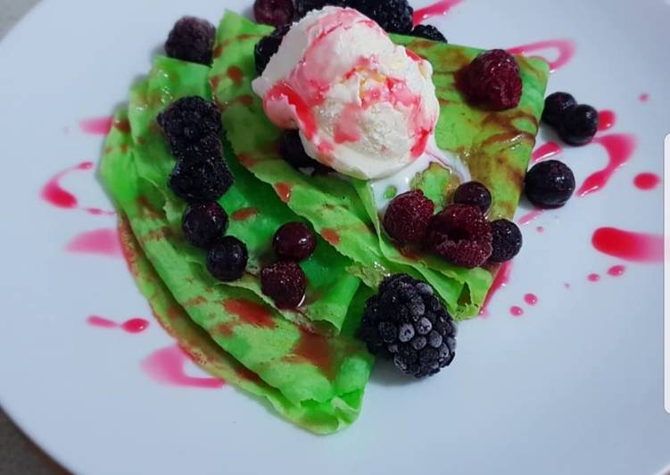 Indonesian crepes with ice cream and mixberry on top Indonesian crepes with ice cream and mixberry on top