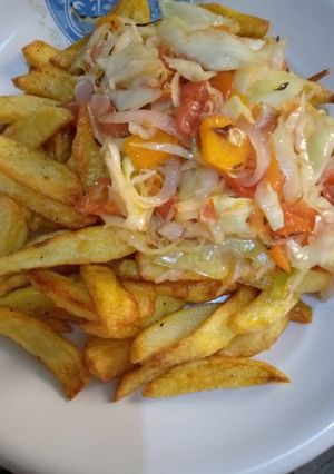 A picture of Chips and vegetable sauce.