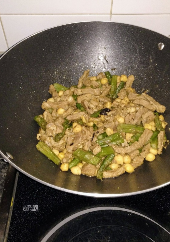 Una foto de Wok de cordero al curry salteado con espárragos verdes y garbanzos