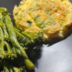 A picture of Spring onion & Cheese baked omelette with buttered vegetables.