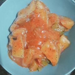 A picture of Schezwan potato wedges.