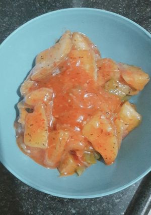A picture of Schezwan potato wedges.