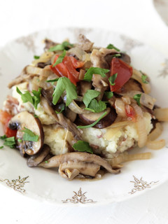 A picture of Fricassee of Mixed Mushrooms over Smashed Rosemary Potatoes.
