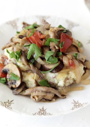 A picture of Fricassee of Mixed Mushrooms over Smashed Rosemary Potatoes.