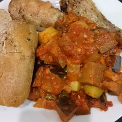 A picture of Chicken with ragout and crusty bread.
