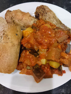 A picture of Chicken with ragout and crusty bread.