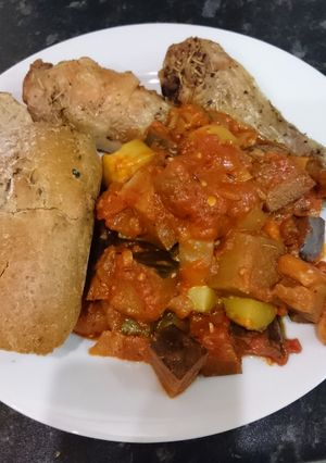 A picture of Chicken with ragout and crusty bread.