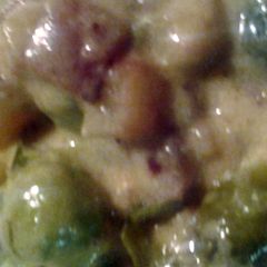 A picture of Brussel sprouts bacon potatoes and cheese sauce.