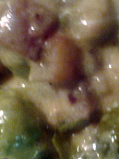 A picture of Brussel sprouts bacon potatoes and cheese sauce.