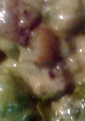 A picture of Brussel sprouts bacon potatoes and cheese sauce.