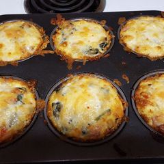 A picture of Cheesy hash brown egg nests.