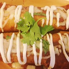 A picture of Shredded Pork Mole Enchilladas.