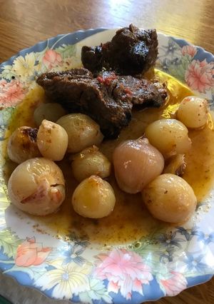 A picture of Beef Stifado in a Dutch Oven.