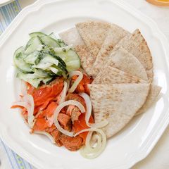 A picture of Salmon with Minted Creamy Cucumbers and Fresh Pita.