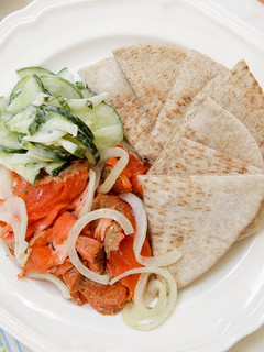 A picture of Salmon with Minted Creamy Cucumbers and Fresh Pita.
