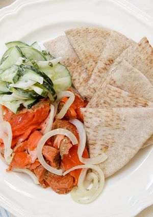 A picture of Salmon with Minted Creamy Cucumbers and Fresh Pita.