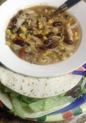 A picture of Shredded Mexican Chicken soup or Tacos.