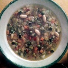 A picture of Minestrone with pesto.