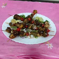 A picture of Grilled baby potatoes and tomatoes with green chattny.