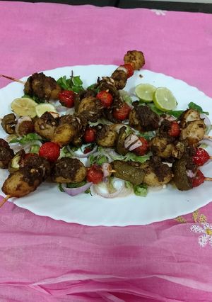 A picture of Grilled baby potatoes and tomatoes with green chattny.