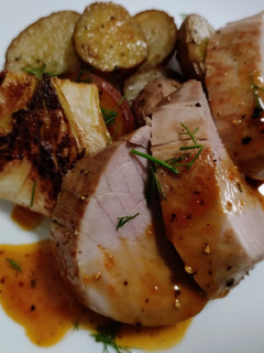 A picture of Pork tenderloin with orange and fennel sauce.
