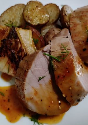 A picture of Pork tenderloin with orange and fennel sauce.