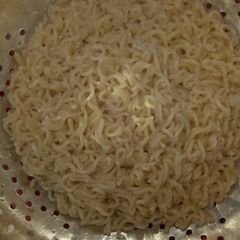 A picture of Indomie noodles with onion.