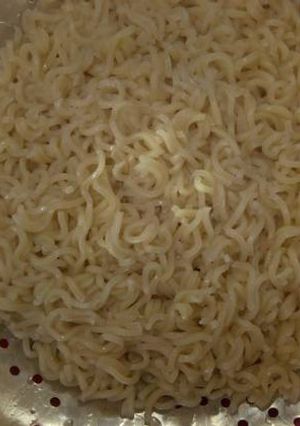 A picture of Indomie noodles with onion.