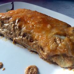 A picture of Chicken and avacado enchiladas in creamy avacado sauce.