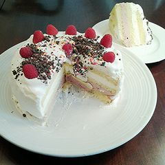 A picture of Butter Cake filled with Rasberry and Lemon Whipped Cream, with a Vanilla Whipped Cream Topping.