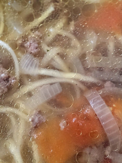 A picture of Ground beef soup with noodles.