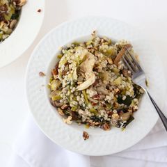 A picture of Toasted Barley Pilaf with Mixed Mushrooms and Leeks topped with Manchego Cheese and Toasted Walnuts.