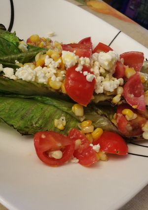 A picture of Grilled Hearts of Romaine with Tomato and Corn.
