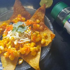 A picture of Nachos with corn salsa.
