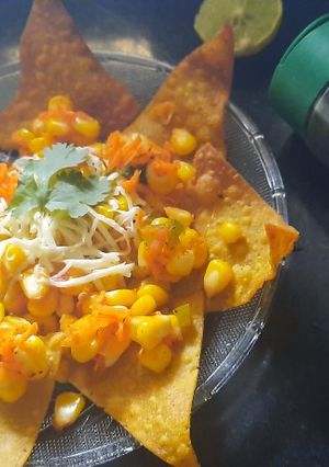 A picture of Nachos with corn salsa.