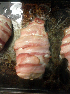 A picture of Bacon wrapped chicken stuffed with ham and cheese.