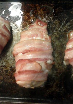 A picture of Bacon wrapped chicken stuffed with ham and cheese.